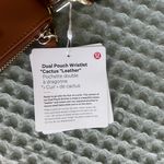Lululemon NWT  Dual Pouch Wristlet
Cactus Leather
Chestnut Brown/Gold Photo 2