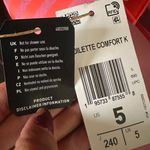 Adidas ADILETTE COMFORT K sandals pink orange super soft comfy light weight NWT New with tag Same day shipping Smoke and pets free Get ready to step up your style with these Adilette Comfort K sandals! These sandals are perfect for those who want to look fashionable while staying comfortable. With a super soft and lightweight design, these sandals are perfect for all-day wear. The pink and orange striped pattern adds a pop of color to your outfit, making them a great choice for any occasion. These sandals come in a UK shoe size 5, US shoe size 5, and EU shoe size 37. The synthetic upper material and comfort slide product line ensure that your feet will stay cool and comfortable no matter where you go. Don't miss out on the chance to add these stylish and comfortable sandals to your shoe collection! Photo 4