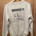 Uniqlo x kaws sweatshirt size small multiple stains in right wrist area as seen in picture Photo 8