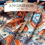 Angashion | Navy/burnt orange print short sleeve scoop neck top with tie accent. Photo 6