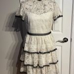 Shoshanna Stacia Lace Tiered Polka Dot Knee Length High Neck Black trim on neck/sleeve/bottom Hidden back zipper A flutter sleeve ballet lace fit-and-flare mini dress with ruffle detail below the waist ivory cream Kentucky Derby mock sheer layer Photo 2