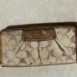 Coach  signature Charlie C zip around wallet gold with purple interior Photo 1