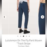 Lululemon  On The Fly Woven Track Black Stripe Pant in True Navy, Size 10 Photo 2