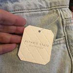 Altar'd State  high-waisted light wash ripped distressed raw hem jeans Size 27 Photo 4
