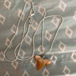 Wrapped Shark Tooth Necklace. Tan color and approximately 1” Tall. Photo 1