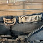 Indigo Rein  medium/light was distressed button front denim mini skirt. Photo 5