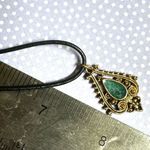 Green and gold tone pendant necklace on black cord Photo 4