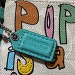 Coach  Poppy Woodmark Multicolor Text Wristlet with Teal Accents. Photo 2