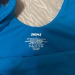  Soft Stretch Bodysuit – Blue SKIMS bodysuit in a bright blue shade. Super soft and stretchy with a smooth, flattering fit. Only worn once and stored in a dresser since. No flaws. Photo 1
