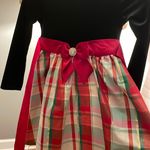 This dress is a rare edition girls' holiday dress, often featuring a black velvet bodice and a metallic plaid taffeta skirt rare edition with a bow on back. Size 6 Photo 1