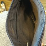 Crossbody dark blue with a Z emblem on the front but no markings on the bag.​​​ Photo 2