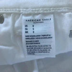 American Eagle  high rise shortie white jean shorts in size 0 Photo 3