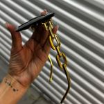 Stylish black sunglasses featuring a gold chain design. Photo 2