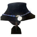 Elegant gold tone and blue evil eye necklace. Photo 2