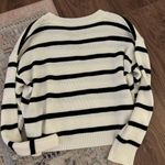 White and black sweater Photo 1