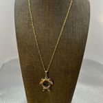 Adorable, gold tone necklace with a turtle the eyes are glass.​ Photo 0