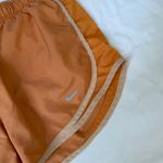 Nike  dri fit orange running shorts size women’s medium Photo 1