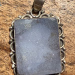 None sterling silver pendant with a rectangular moonstone ornate bezel setting. Photo 0