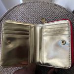 Steve Madden red leather wallet with gold zipper and snap closure, featuring card slots and coin pocket. Photo 1