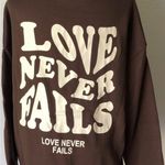 SheIn  Brown Hoodie with 'Love Never Fails' Graphic Photo 3