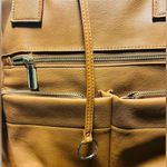 Brown patent leather diaper bag with multiple pockets and key holders Photo 9