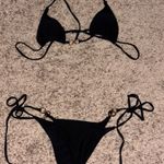 Black swimsuit with gold ring detail Photo 1
