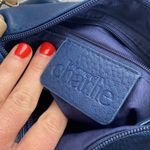 Charming Charlie small blue crossbody bag with tan strap. Photo 2