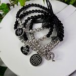 Set of 4 Black and Silver Stretch Bracelets with Asian Charms Photo 0