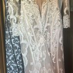 Allure Bridal  Wedding Dress Style; F239 Andi Was altered to fit me at 5’2. The dress does have a few small tears in the train which are pictured. A bustle was added to the dress the train can be tied up. Any extra fabric from being altered was also saved. Photo 8