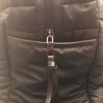 Cynthia Rowley Anthropologie’s Quilted Puffer Travel Bag is a stylish and functional accessory designed for travel enthusiasts. Crafted from high-quality materials, this bag features a quilted exterior for added texture and durability. Its spacious interior provides ample room for belongings, while the thoughtful design includes convenient pockets for organization. The soft puffer style adds a chic touch, making it suitable for various occasions, whether heading to the gym or embarking on a weekend getaway. With comfortable straps for easy carrying, this travel bag combines practicality with fashionable flair. Photo 4