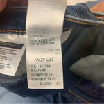 Levi's  size 29 Ribcage bell dark wash denim jeans raw hem flare retro Photo 5