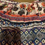 Jolt Looking for something stylish to wear to that concert or music fest coming up? Look no farther. Chic boho style romper with colorful and fun floral and geometric designs. Ideal for casual outings, the beach, and fun times with friends. Brand Romper. Juniors size small. Photo 3