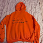 Adika  Orange Evil Eye Hoodie Photo 1