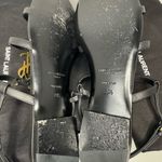 Saint Laurent CASSANDRA LEATHER WITH GOLD EMBLEM HARDWARE IN BLACK SANDALS. Photo 7