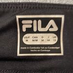 FILA Black & blue athletic skort, has a pocket in the waistband, excellent condition, size medium Measurements: Waist: side to side 16-19 inches Length: waistband to bottom 13 1/2 inches Photo 5
