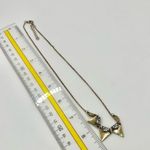 Gold tone triangle rhinestone necklace Photo 6