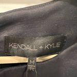 Kendall + Kylie NWT  Black Sleeveless Top with laser cutout at hem. Photo 1