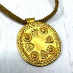 Mayan design gold tone pendant purchased in Costa Rica, on golden suede cord Photo 0