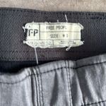 Free People jeans. Tight to knee then flare bottom. Color- black. Size 30 Photo 2