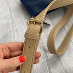Charming Charlie small blue crossbody bag with tan strap. Photo 6