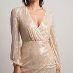 Cloud Ten One Way TICKET LONG SLEEVE SURPLICE DRESS IN GOLD Photo 0