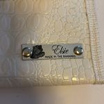 ELSIE…MADE IN THE BAHAMAS WHITE FAUX SKIN CLUTCH WITH STRAW DESIGN SNAP CLOSURE Photo 1