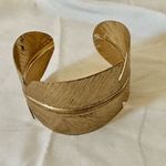 Gold tone feather cuff bracelet Photo 1