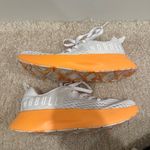 Nobull Journey running shoe in white with an orange midsole Photo 3