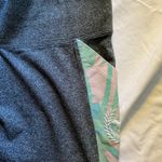 PINK - Victoria's Secret  YOGA-GRAY AND FLORAL LEGGINGS  Gray yoga leggings with floral and white sides, side pockets, great condition, size large Measurements:  Waist: side to side 16-19 inches  Rise: 10 inches  Inseam: 29 inches  Photo 10