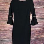 Calvin Klein Black Dress Size 2 Fitted with 3/4 Bell Sleeve With gold Rings. Photo 0