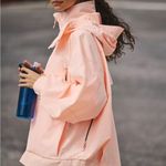 FP Movement Singin’ in the Rain Packable Pullover in Pastel Peach Pink Size XS Photo 1