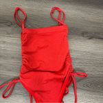 Out from under red bodysuit XS Photo 1