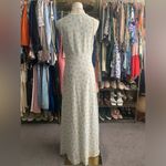 Alyn Paige Long Dress: Elegant 90’s sleeveless dress features A-line silhouette, perfect for any occasion. The delicate fabric drapes beautifully, providing a flattering fit. This timeless piece can be dressed up or down, making it a versatile addition to your wardrobe. Ideal for summer gatherings or evening events, it's a must-have for style enthusiasts. Photo 1