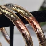 Gold Swirl Diamond Cut Tube Hoop Earrings Photo 2